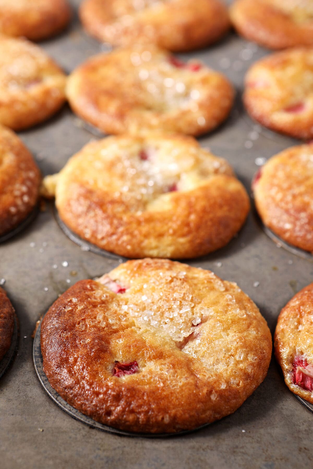 baked strawberry muffins in a muffin tin