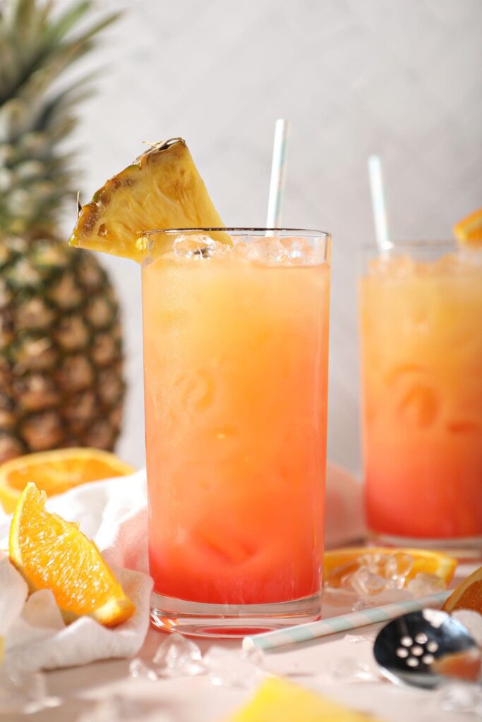 Two Sweet Sunrise easy cocktails garnished with pineapples