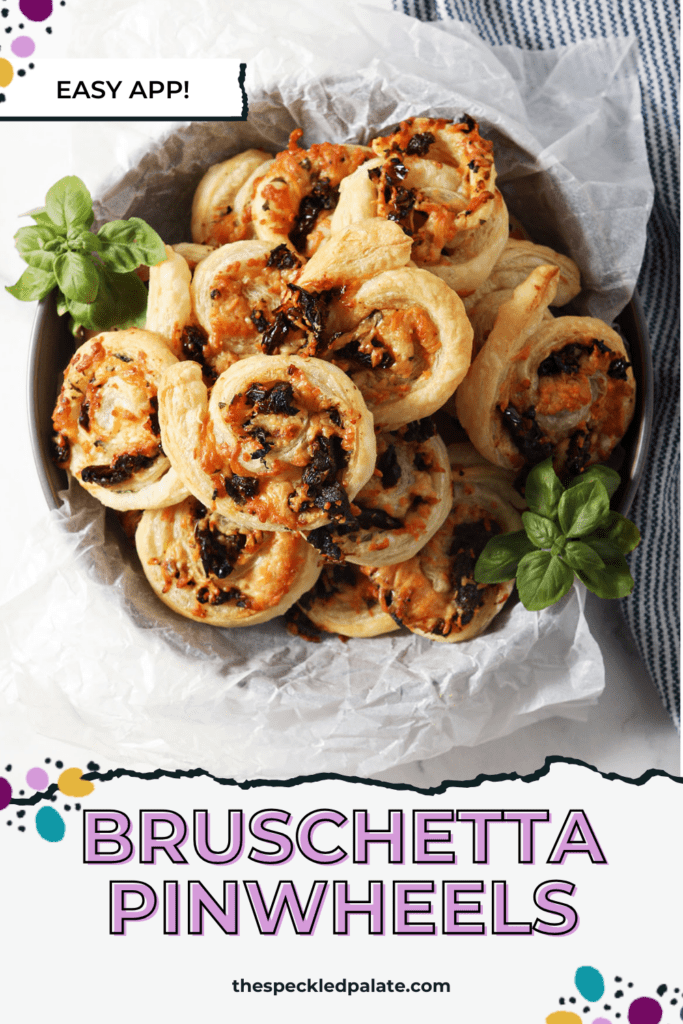 Overhead image of puff pastry pinwheels in a bowl surrounded by fresh basil and a blue linen with the text bruschetta pinwheels