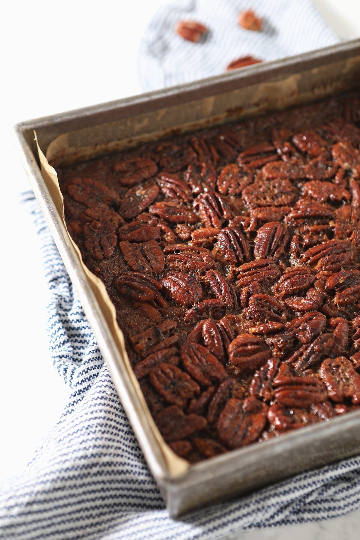 The Bourbon Pecan Pie Bars in a square baking dish after baking