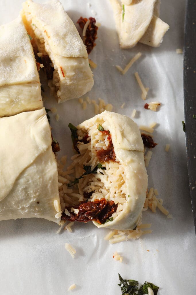 Sliced bruschetta pinwheels on parchment paper