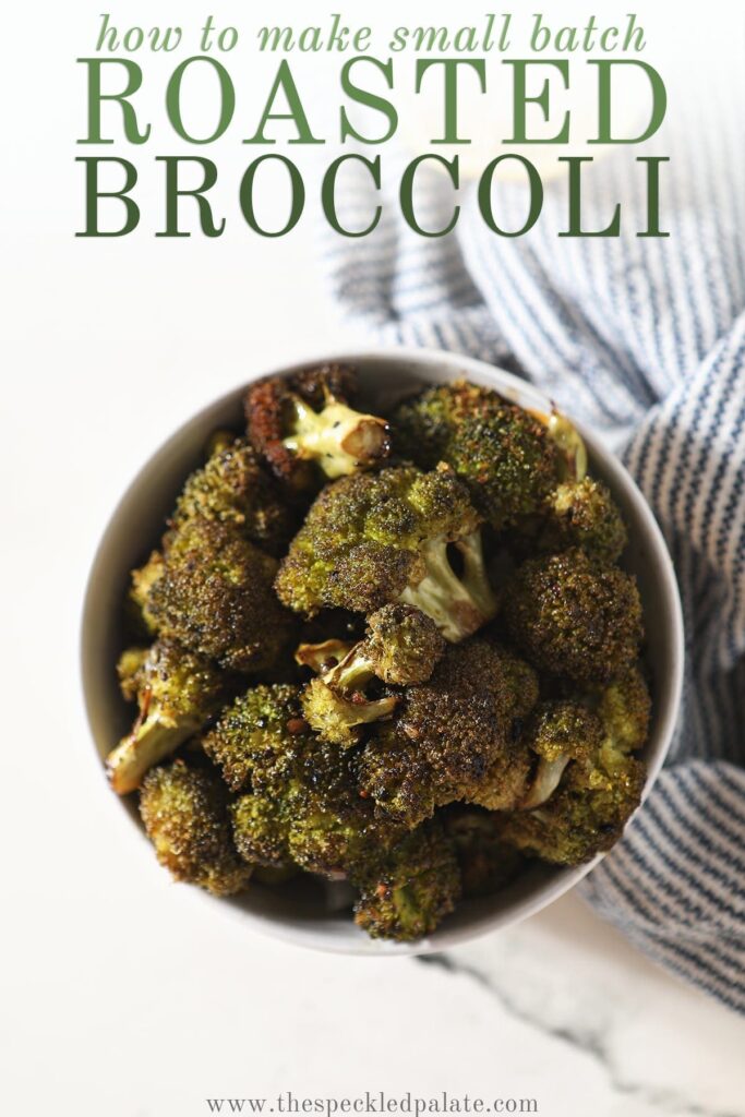 Roasted Broccoli in a bowl sitting on top of a blue and white striped towel next to a lemon wedge with the text 'how to make small batch roasted broccoli'