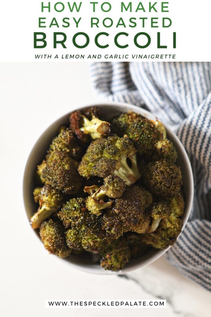 Roasted Broccoli in a bowl sitting on top of a blue and white striped towel next to a lemon wedge with the text 'how to make easy roasted broccoli with a lemon and garlic vinaigrette'