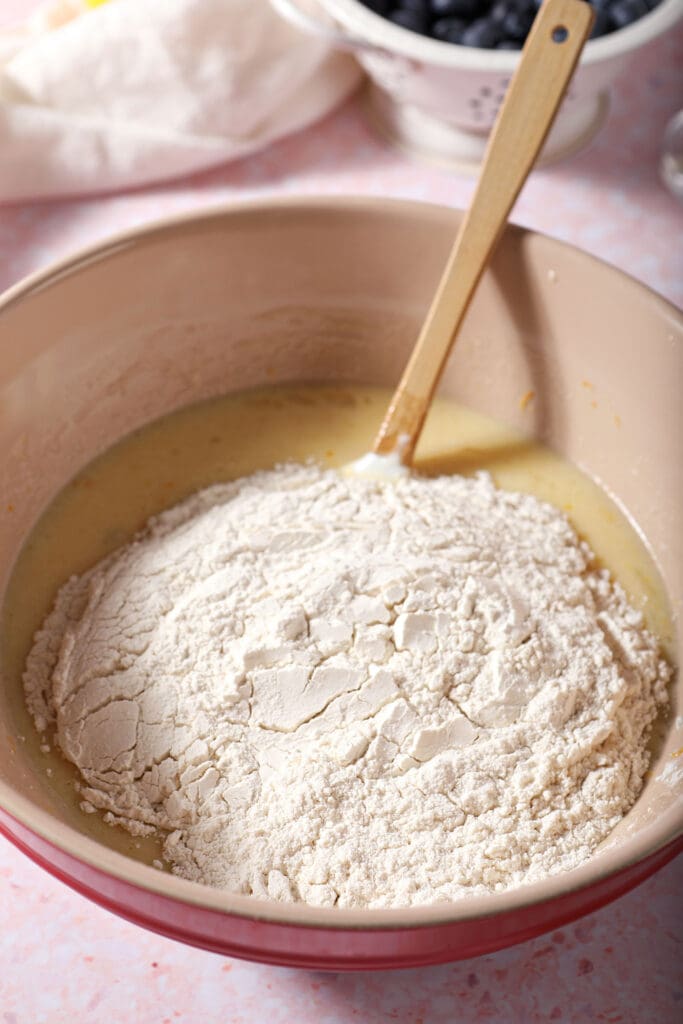 Dry ingredients added on top of wet ingredients in a bowl