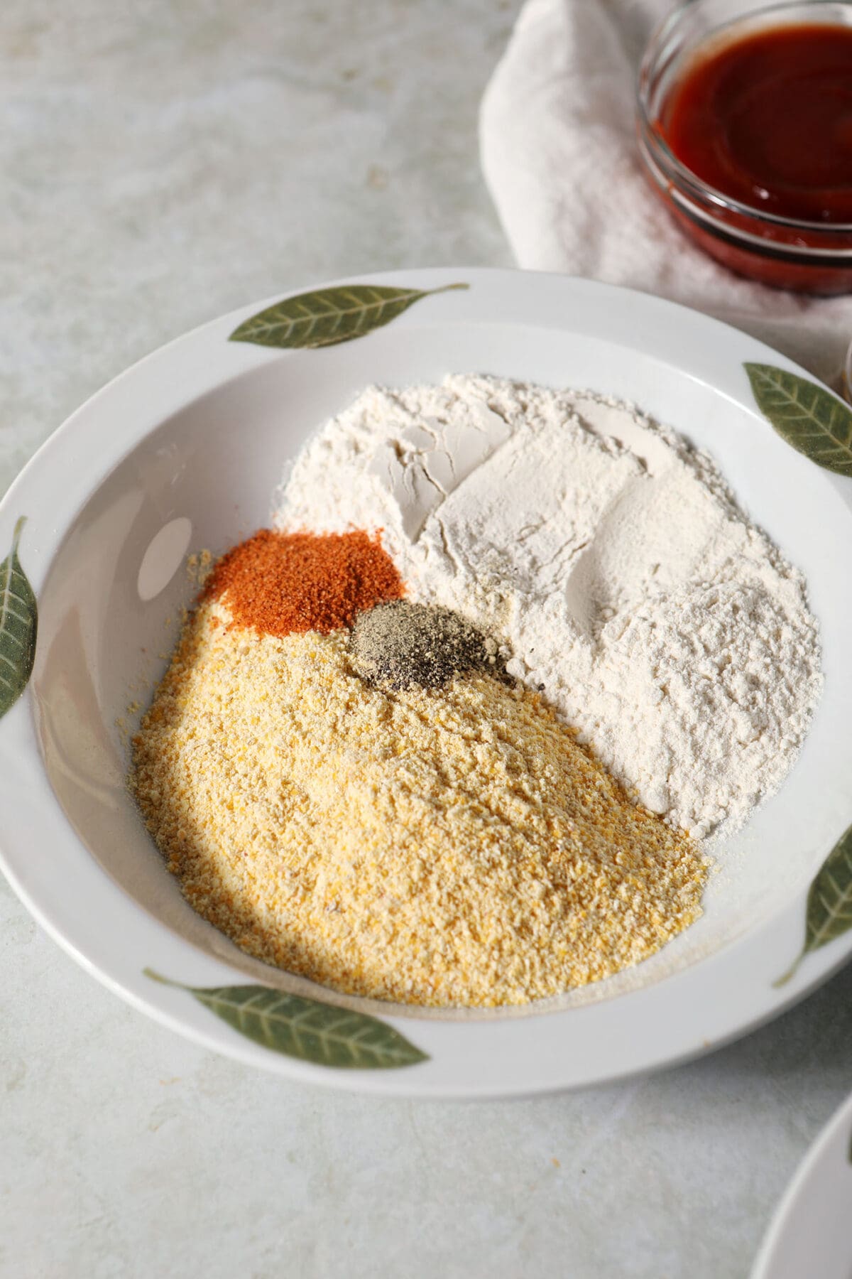 A bowl of dry ingredients to make breading for oven fried pickles
