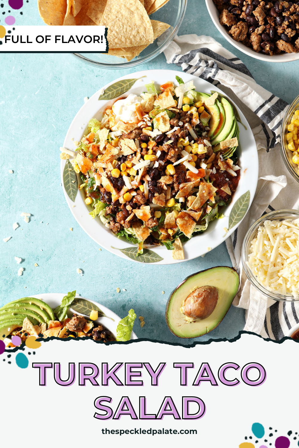 Two dressed taco salads in white bowls on a green countertop surrounded by ingredients with the text Turkey Taco Salad