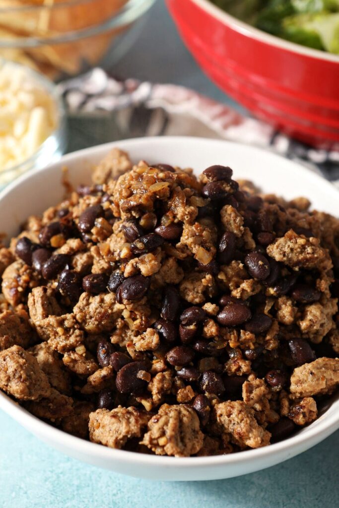 Ground turkey and black beans in a white bowl