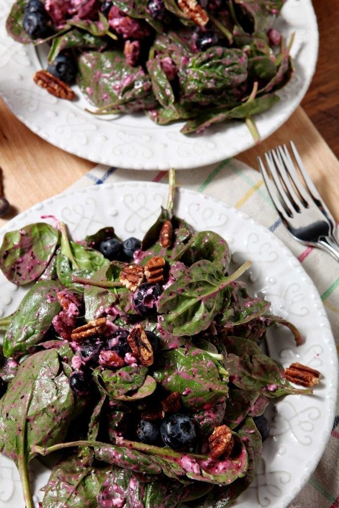 Two plates of Blueberry Pecan Feta Salad, tossed and ready for eating