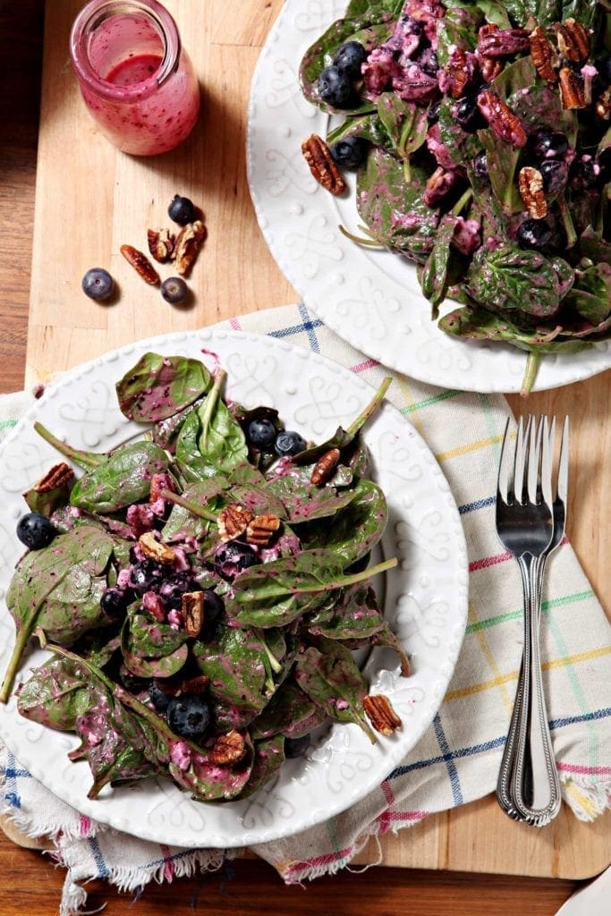 Two plates of Blueberry Pecan Feta Salad, tossed and ready for eating