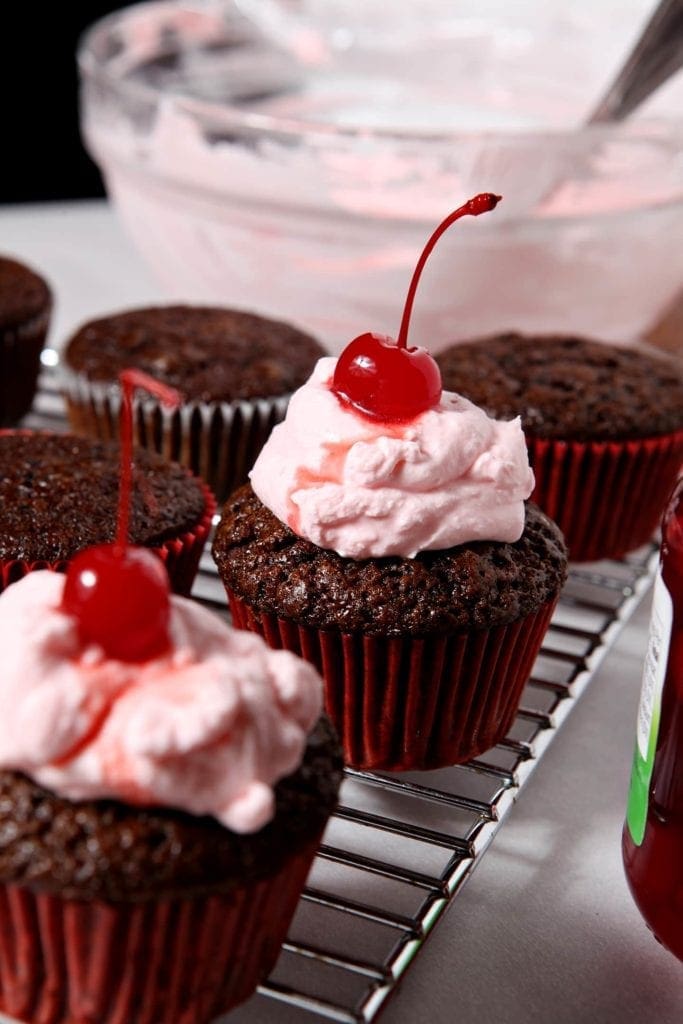 angle view of chocolate cupcakes with cherries 