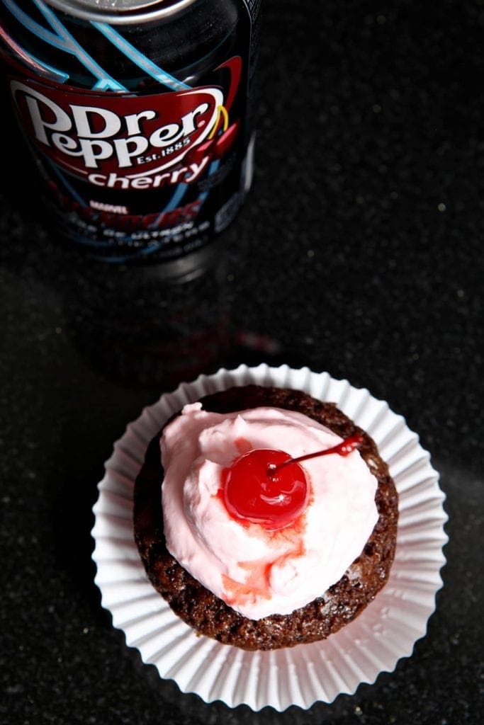 overhead of of chocolate cupcakes with pink icing 