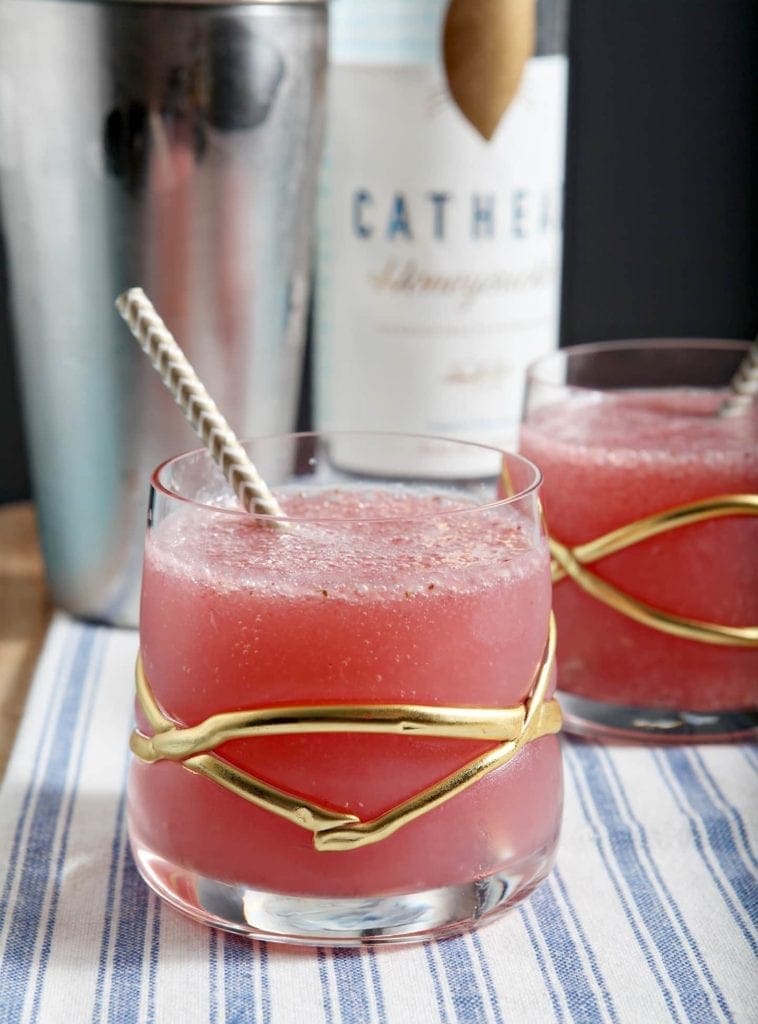 A close up of a glass cup on a table, with Vodka and Mixed drink