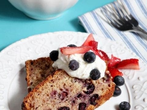 Two slices of berry pound cake with whipped cream and berries