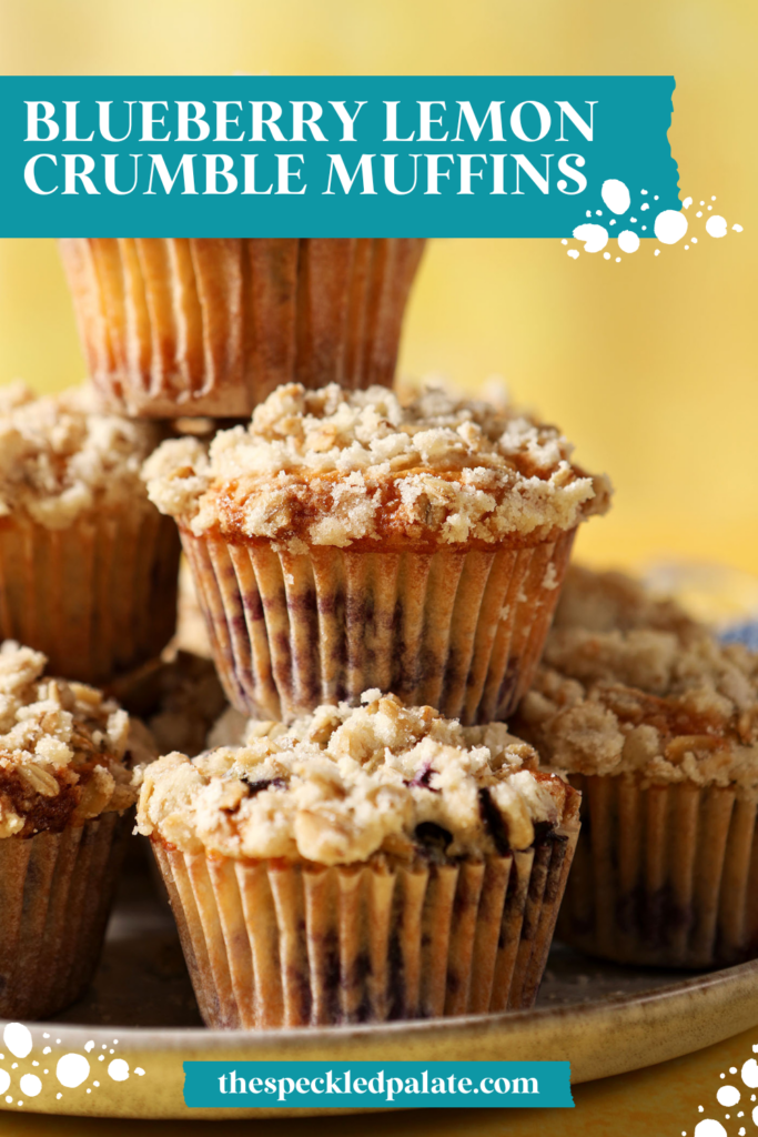 A stack of Lemon Blueberry Muffins with Streusel Topping on a grey plate on a yellow surface near a blue linen with the text blueberry lemon crumble muffins