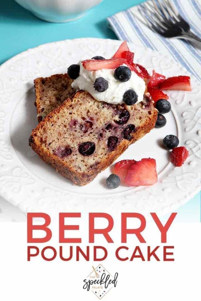 Two sliced pieces of Blueberry Strawberry Pound Cake are served with whipped cream and berries, with Pinterest text