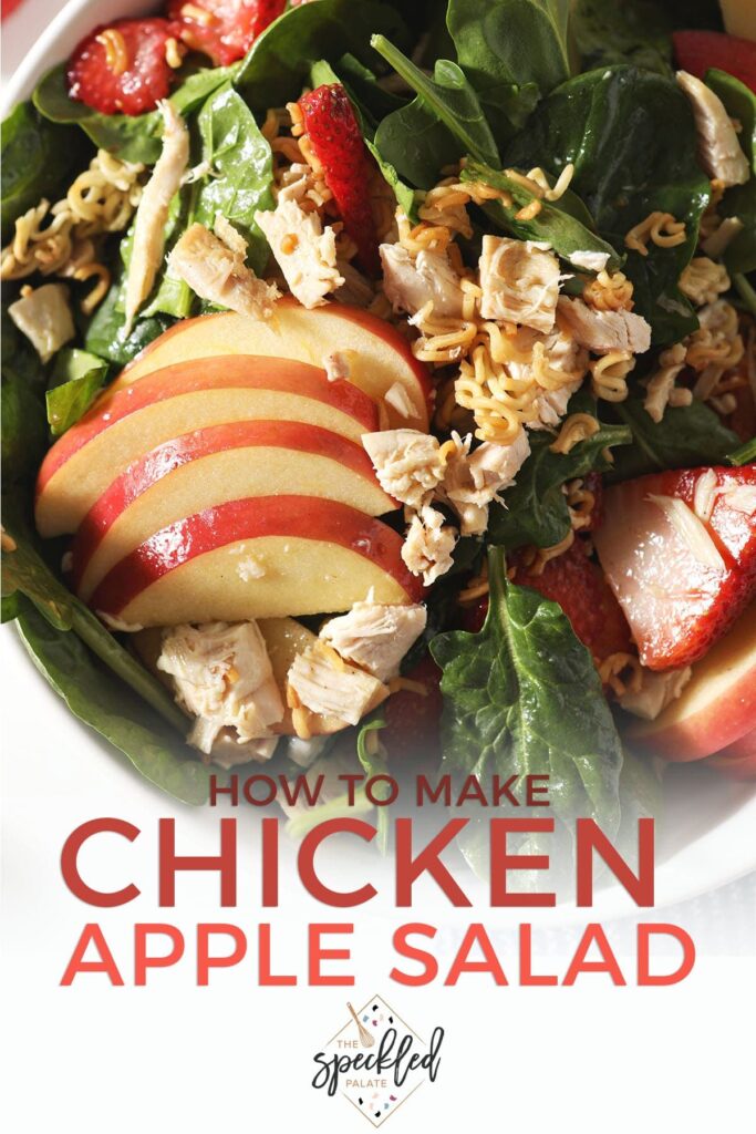 Apples, strawberries and chicken on a spinach salad with the text 'how to make chicken apple salad'