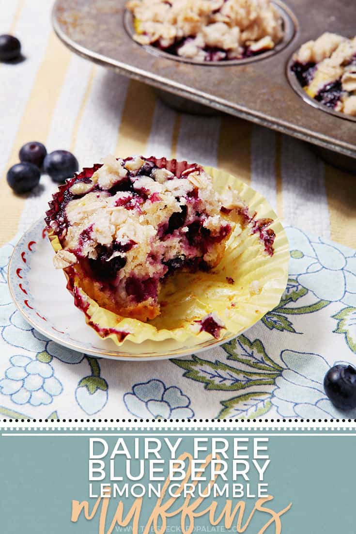 Pinterest photo of Blueberry Lemon Crumble Muffins, with text, showing a half-eaten muffin on a blue floral patterned napkin