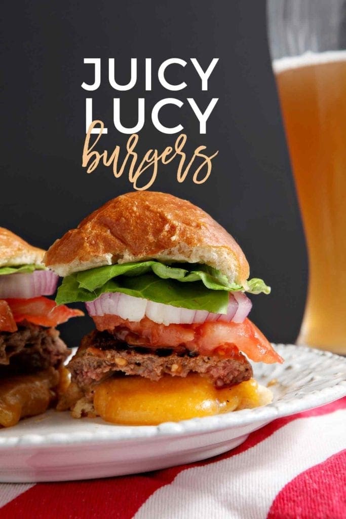 A Juicy Lucy Burger is cut in half with the cheese oozing out of it. Pinterest photo with text.