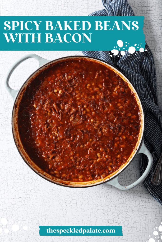 Overhead of baked beans in a pan before baking with bacon crumbles with the text Spicy Baked Beans with bacon