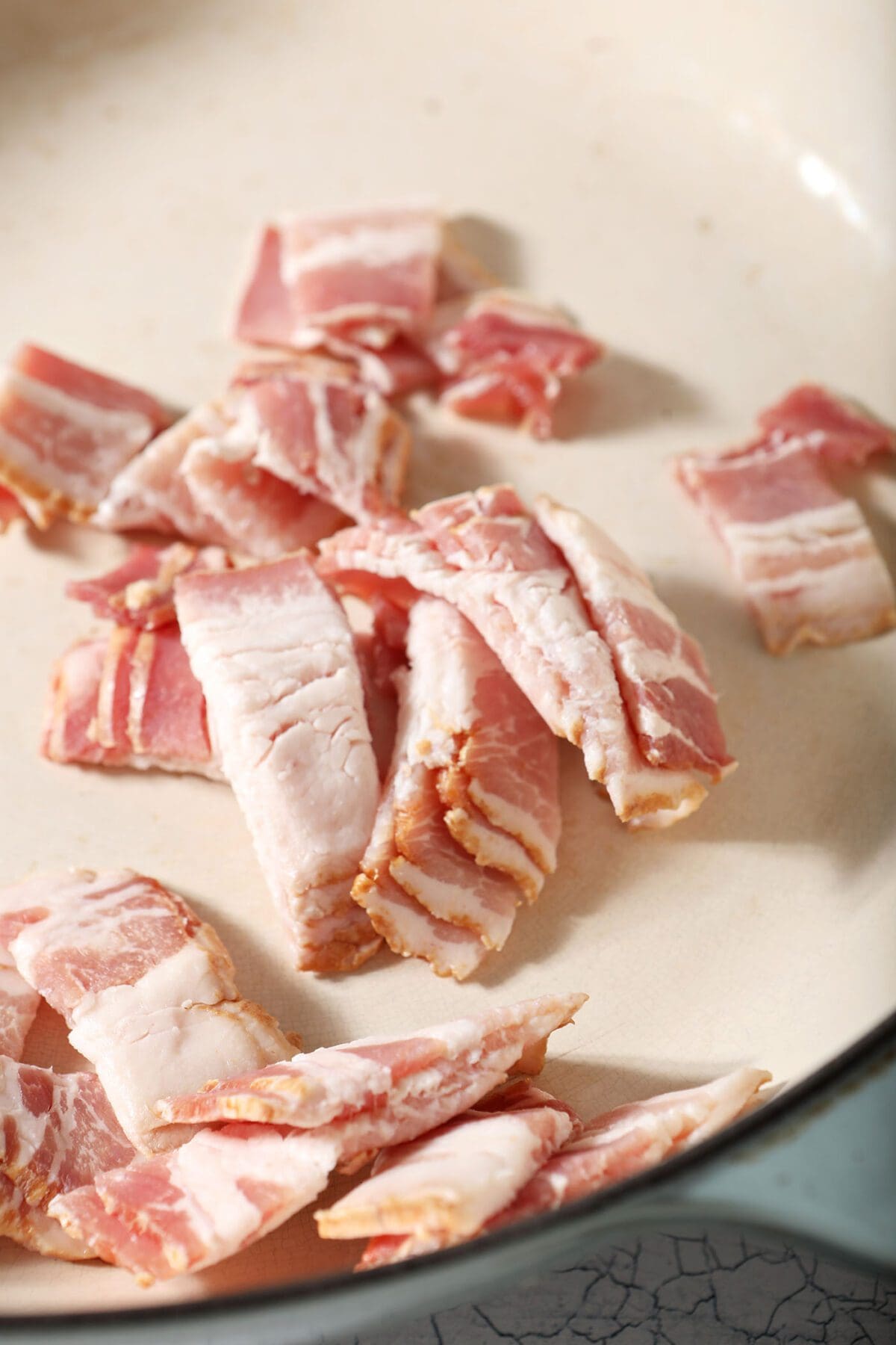 Bacon in a pan before cooking