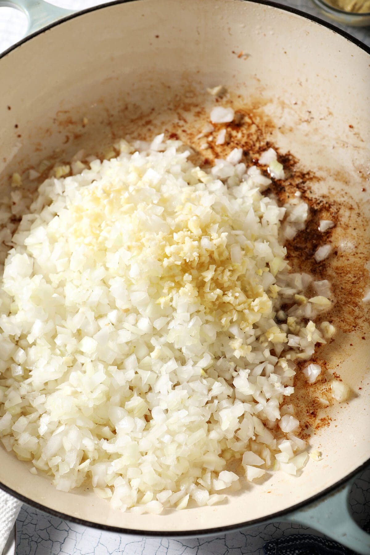 Onions and garlic in a pan with bacon fat