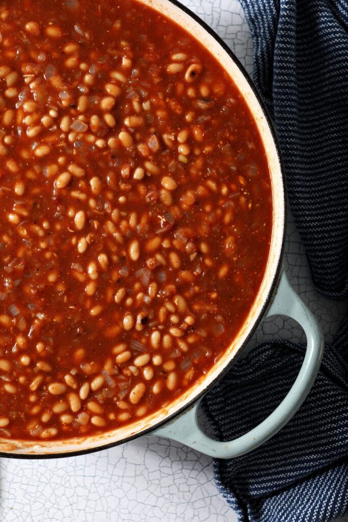 Close up of beans and sauce in a pan before baking