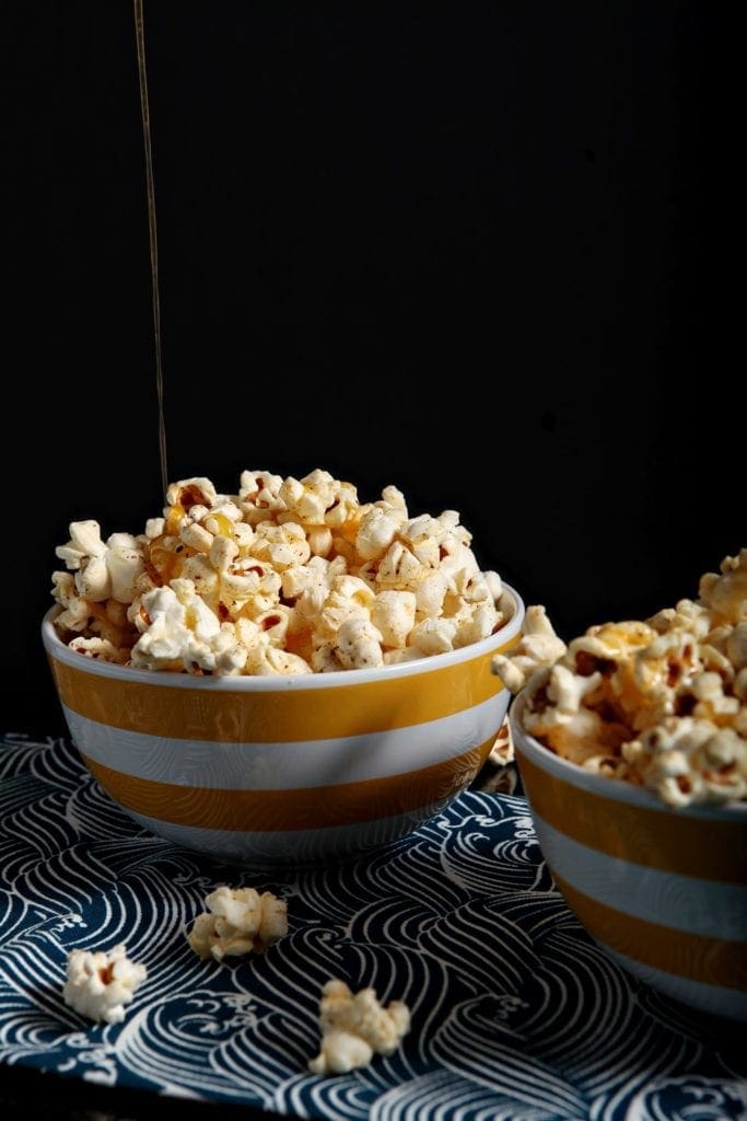 buttered popcorn in a yellow bowl 