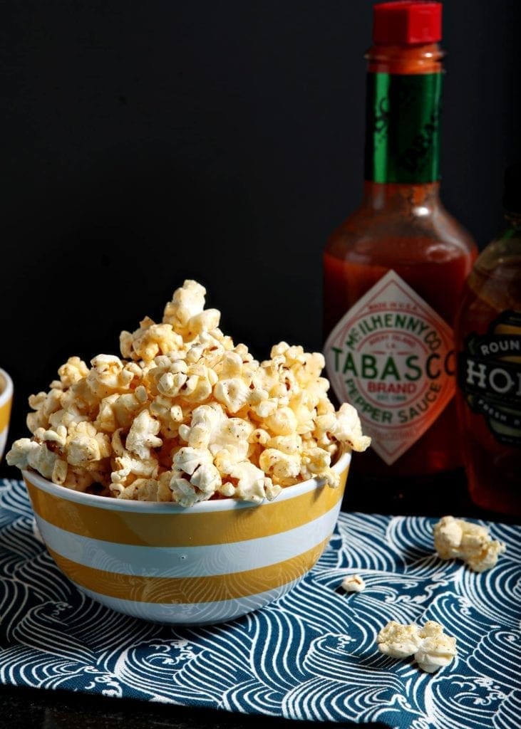 bowl of buttered popcorn with tabasco sauce