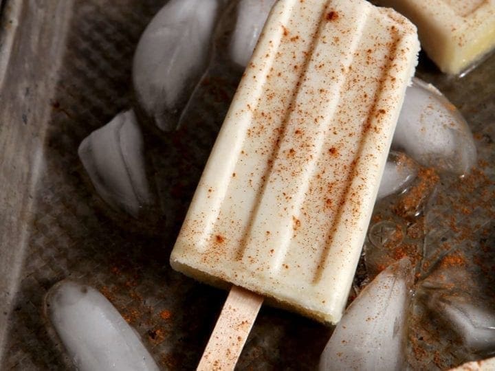 Cool down on a hot summer's day with Spiced Rum Horchata Pops! These vegan popsicles are cinnamon-y, creamy and utterly decadent as an afternoon (or evening) treat.
