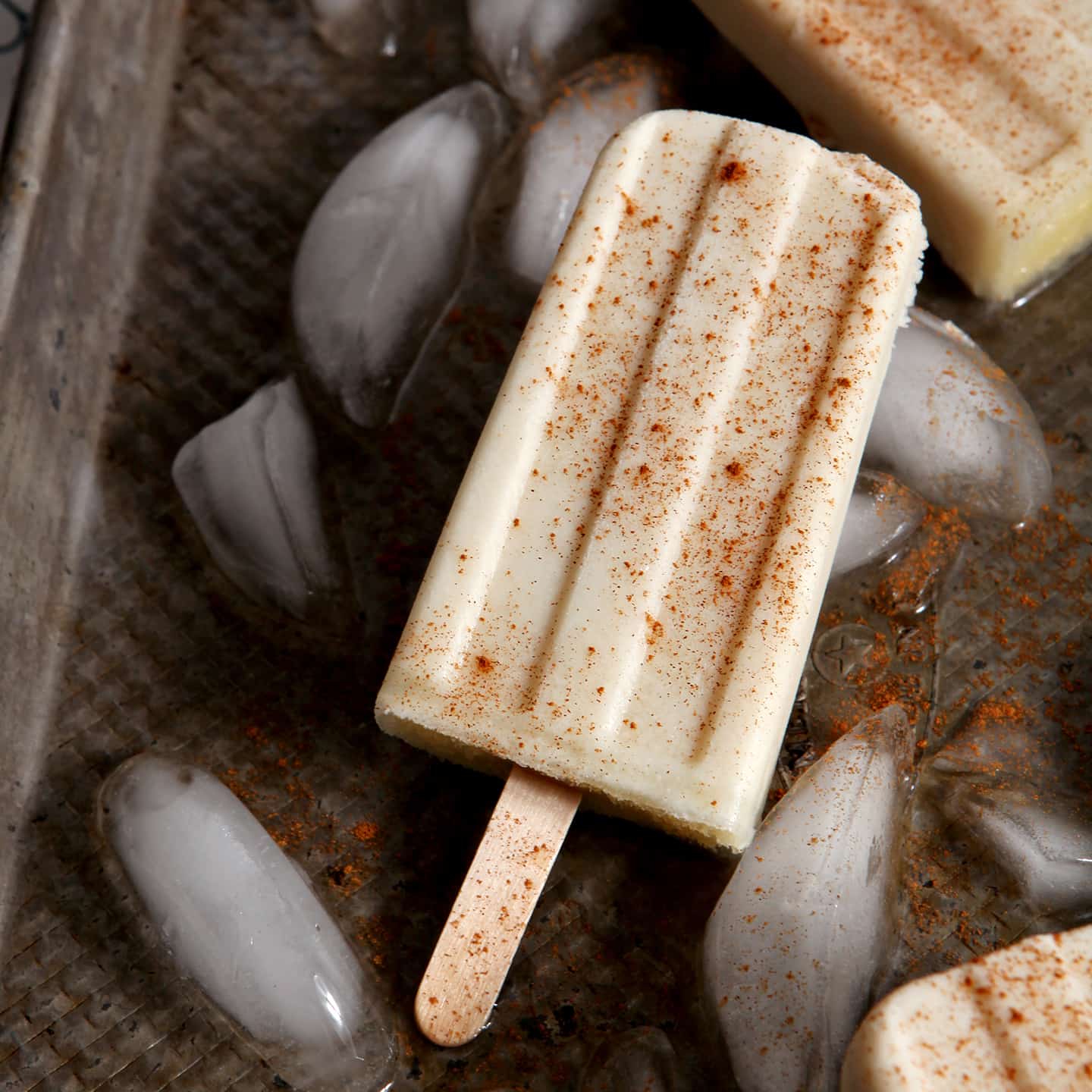 Cool down on a hot summer's day with Spiced Rum Horchata Pops! These vegan popsicles are cinnamon-y, creamy and utterly decadent as an afternoon (or evening) treat.