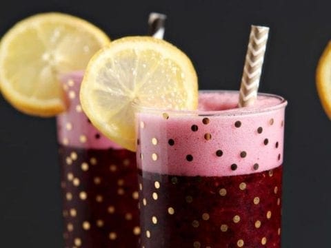 Three glasses of blueberry lemonade vodka with lemon round garnishes