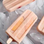 Close up of popsicles laying over ice cubes