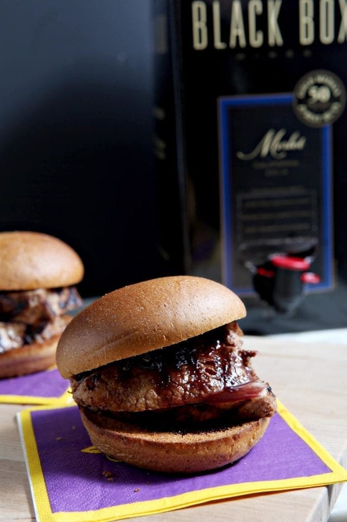 Two sliders in front of box of wine 