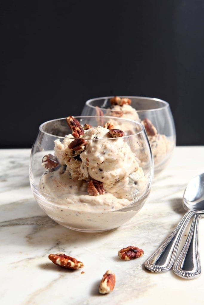 Two clear glass bowls hold no churn peanut butter ice cream with pecans