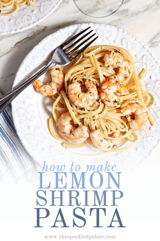 Lemon Shrimp Pasta on a white plate with a fork on marble with a glass of wine with the text 'how to make lemon shrimp pasta'