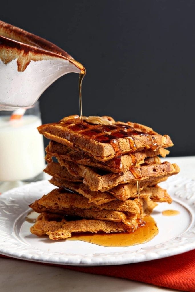 Cinnamon Maple Syrup is drizzled atop Pumpkin Waffles before serving