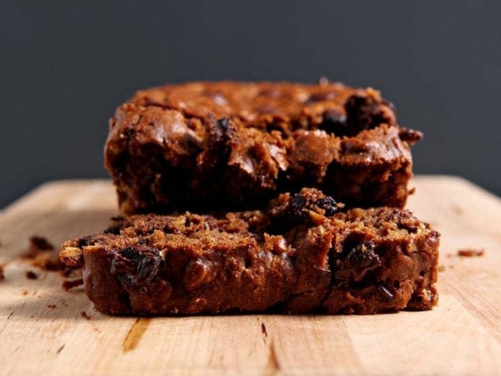 Close up of sliced Gluten Free Pumpkin Bread with Chocolate Chips on a wooden cutting board