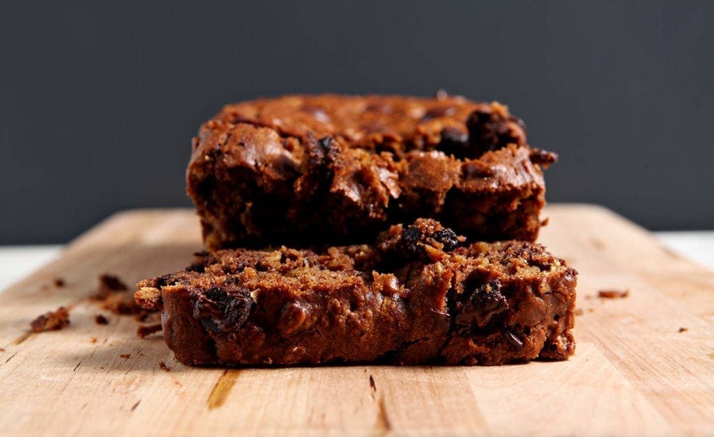 Close up of sliced Gluten Free Pumpkin Bread with Chocolate Chips on a wooden cutting board