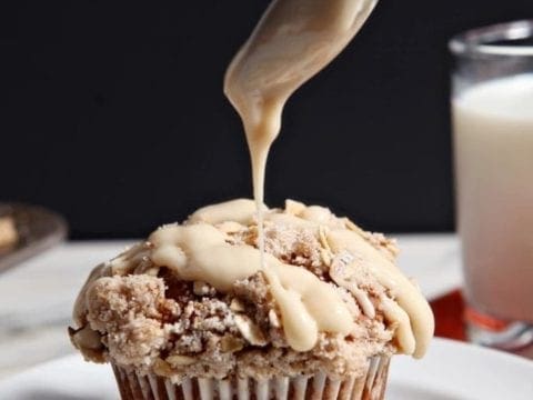 Maple Cream Cheese Glaze is drizzled onto Pumpkin Brown Butter Streusel Muffins