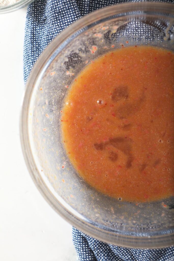 Close up of the wet ingredients for the cupcakes in a glass bowl