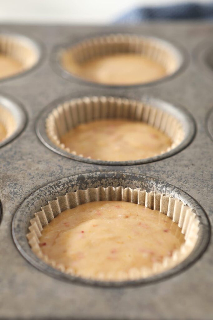 Strawberry cupcake batter in a muffin tin before baking