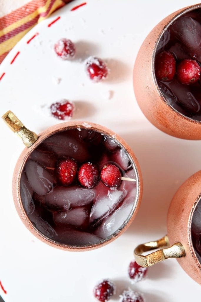 Overhead image of three Cranberry Mules on a white serving platter