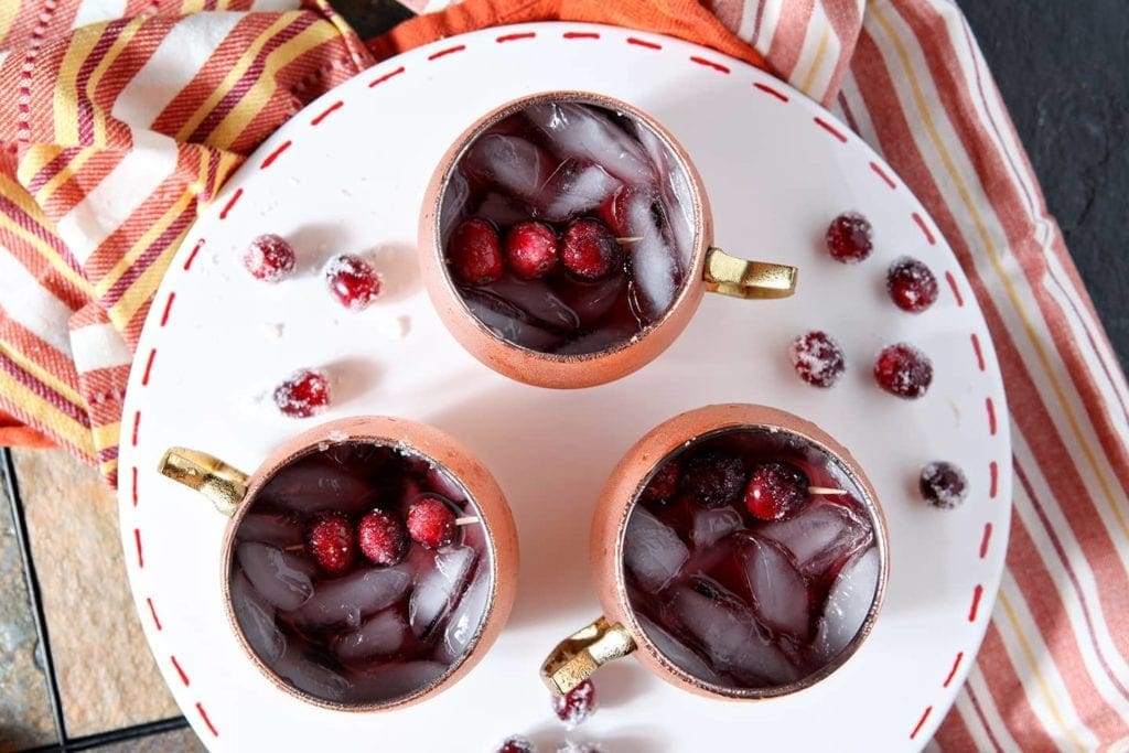 Three Cranberry Mules are served on a white platter, shown from above