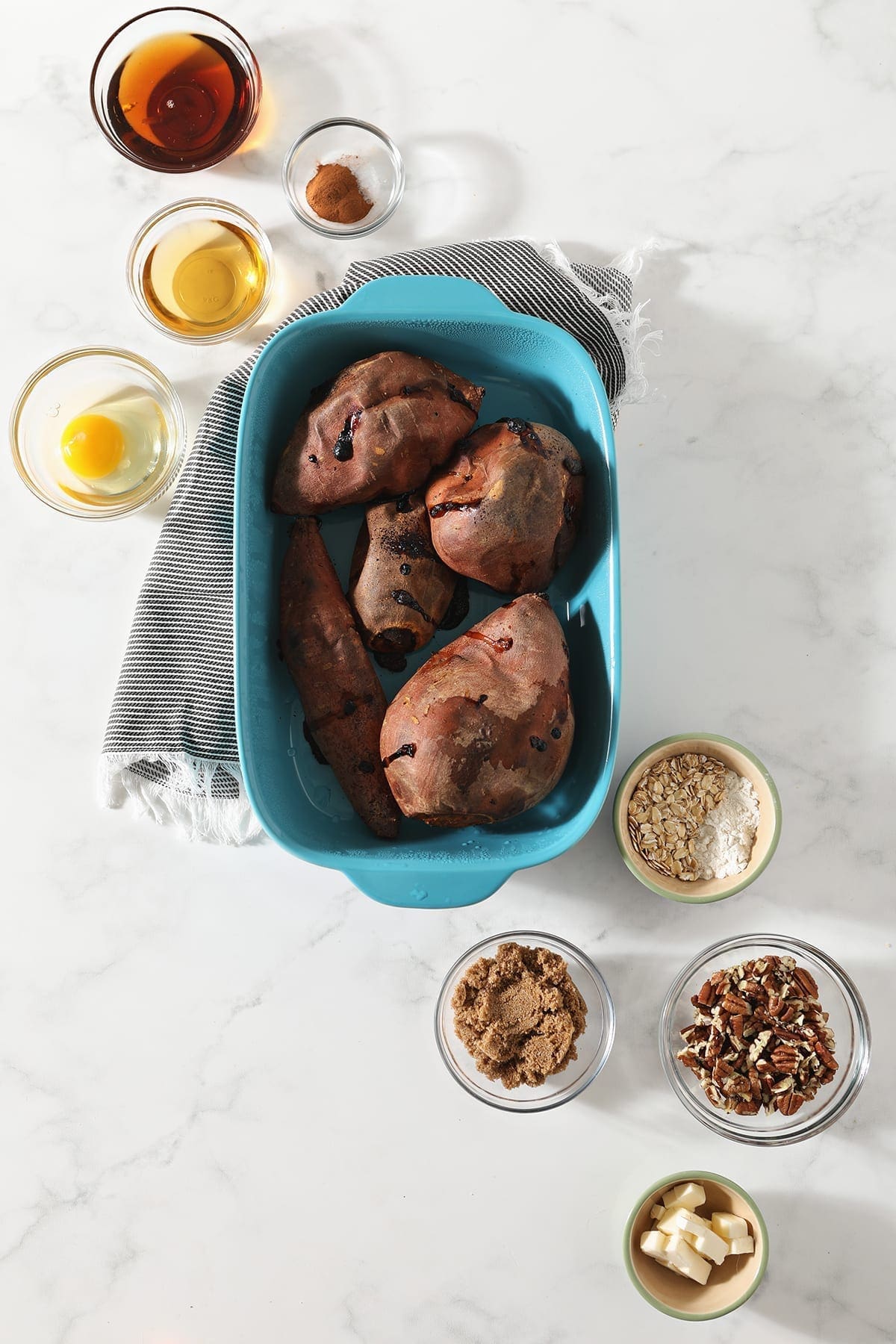 Sweet potatoes and other ingredients to make the casserole in dishes