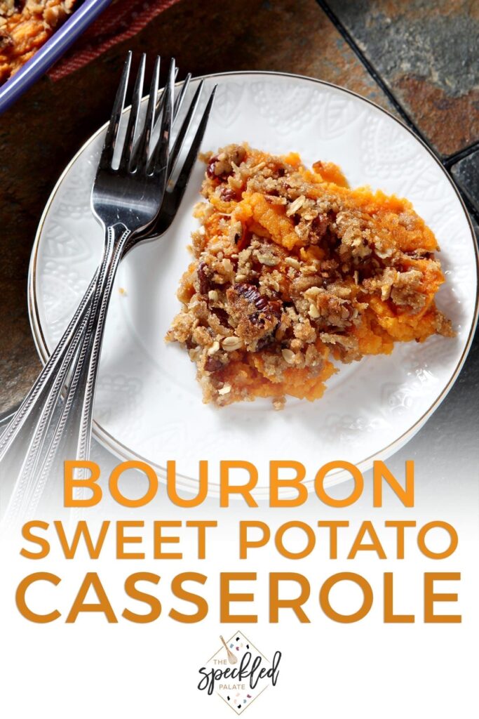 Close up of a white plate holding a serving of Bourbon Sweet Potato Casserole next to two silver forks with the text 'bourbon sweet potato casserole'