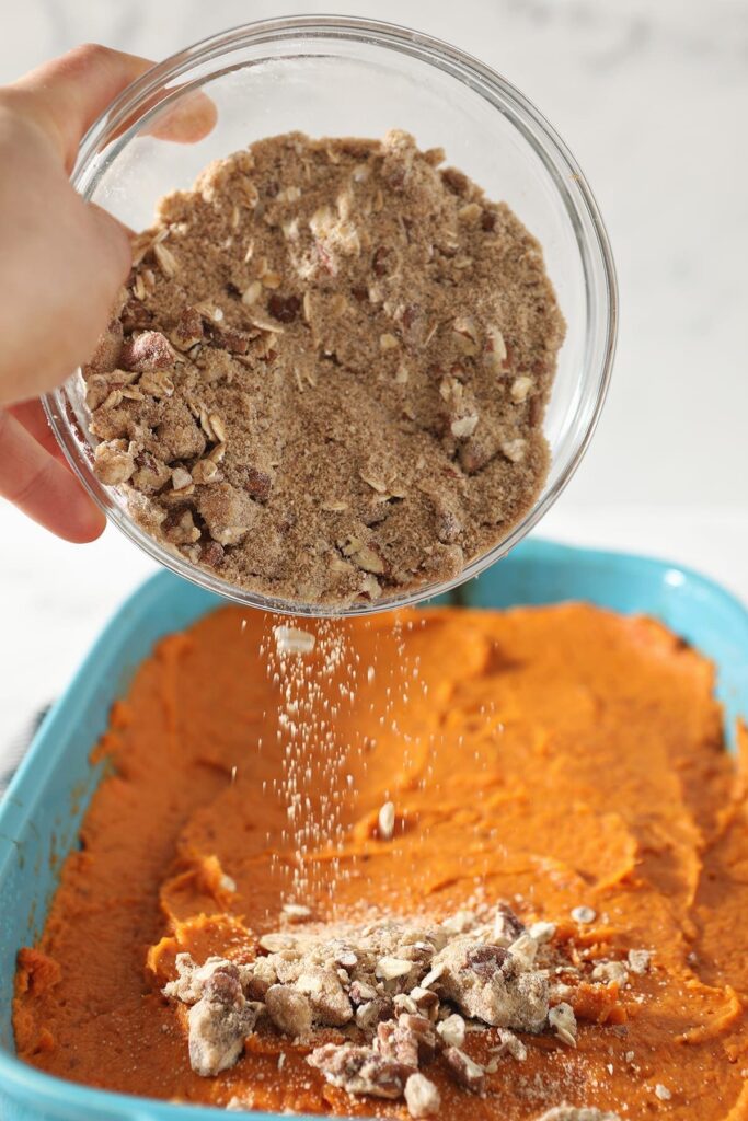 The streusel topping is sprinkled on top of the sweet potato filling