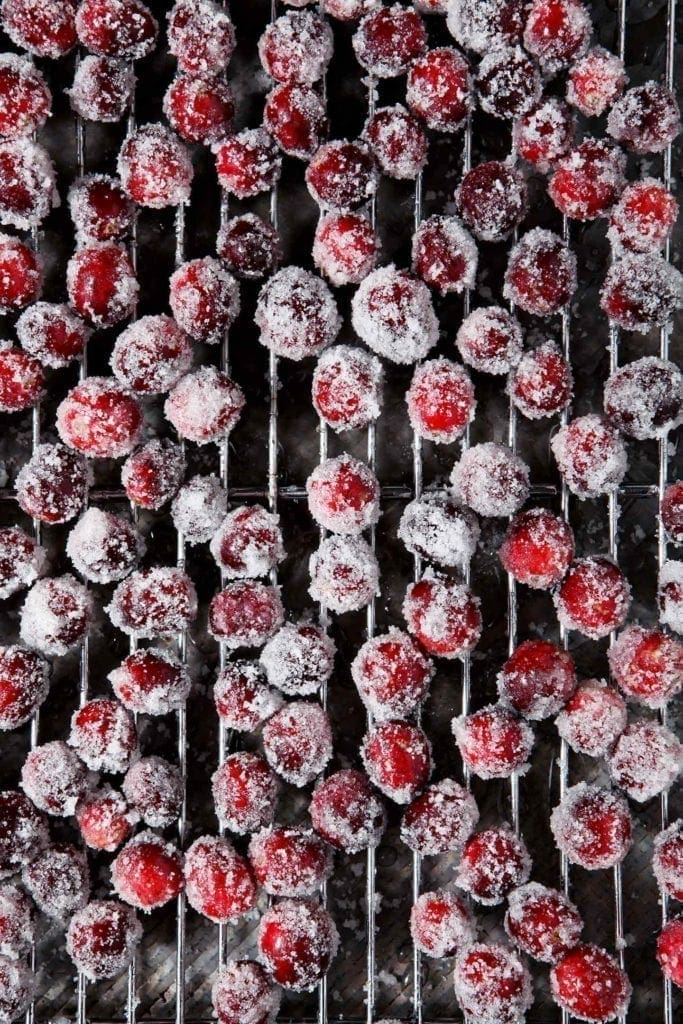 Sugared cranberries dry on a metal cooling rack