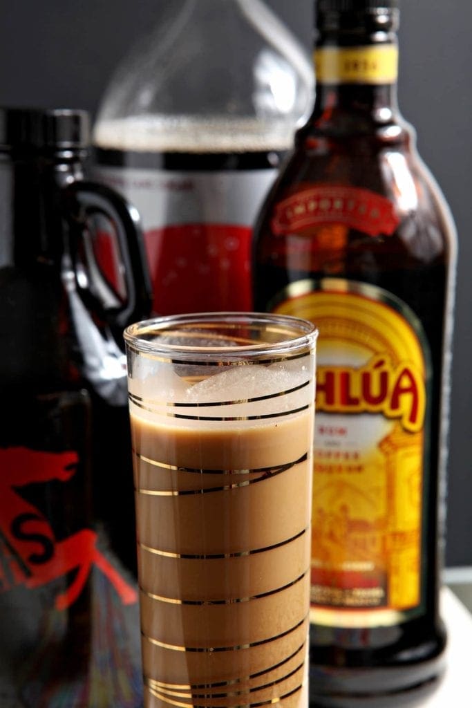 Close up of Melty cold brew shake drink in front of bottles 