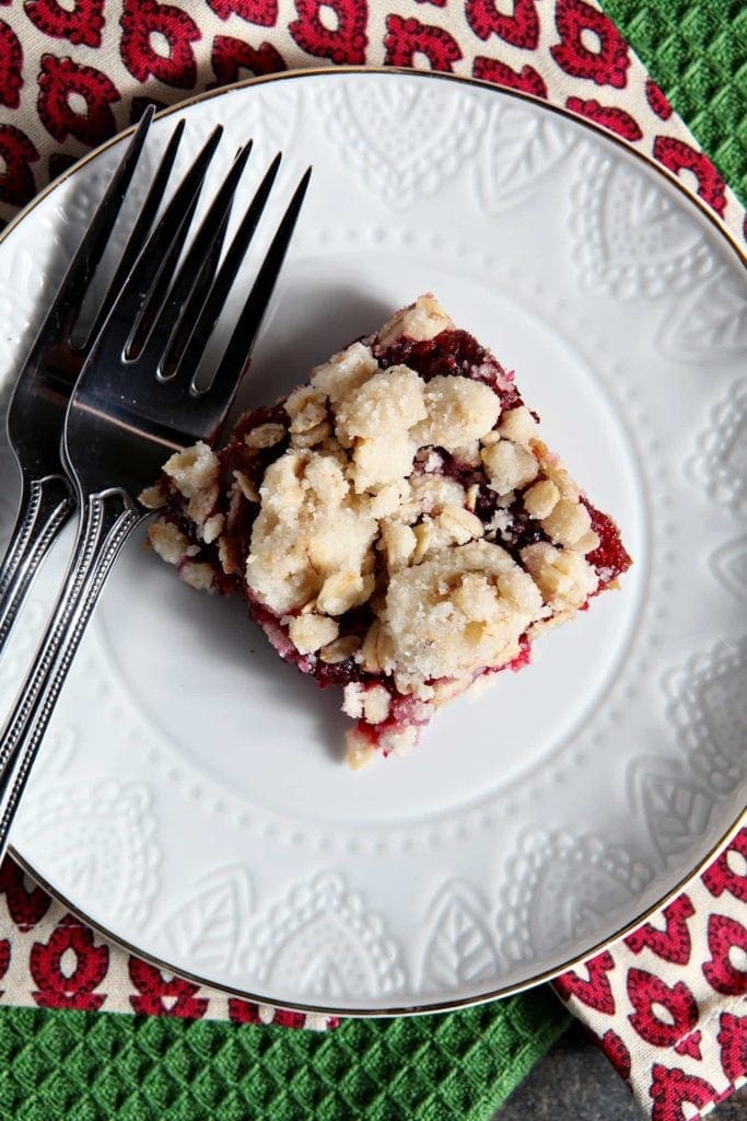 Overhead view of Cranberry Crumb Bar on white plate with forks 