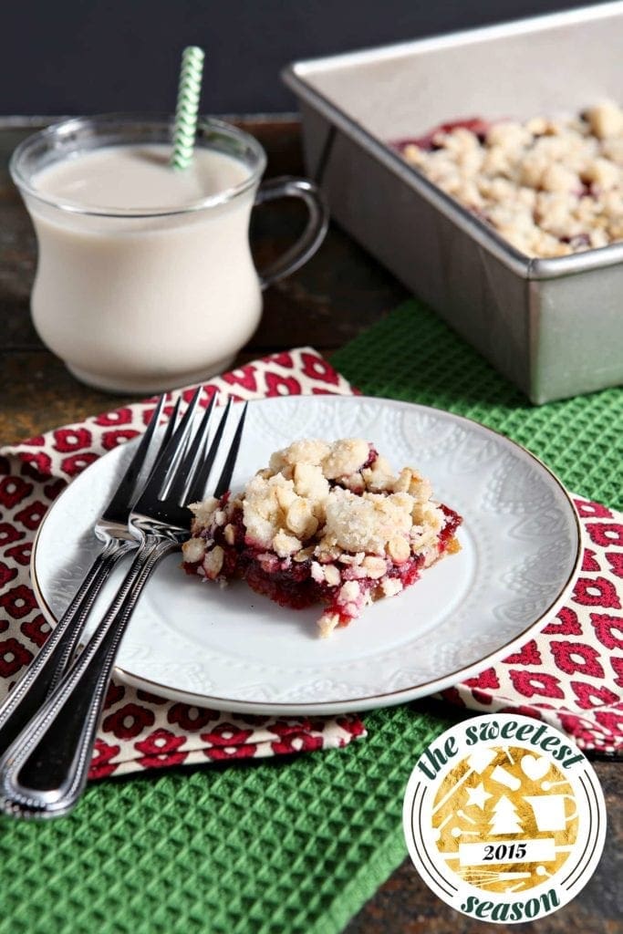 Cranberry Crumb Bar on plate with forks with glass of milk 